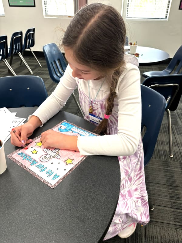 An Anchor Homeschool Co-op student coloring an 'A is for Anchor' worksheet in Lemont, IL