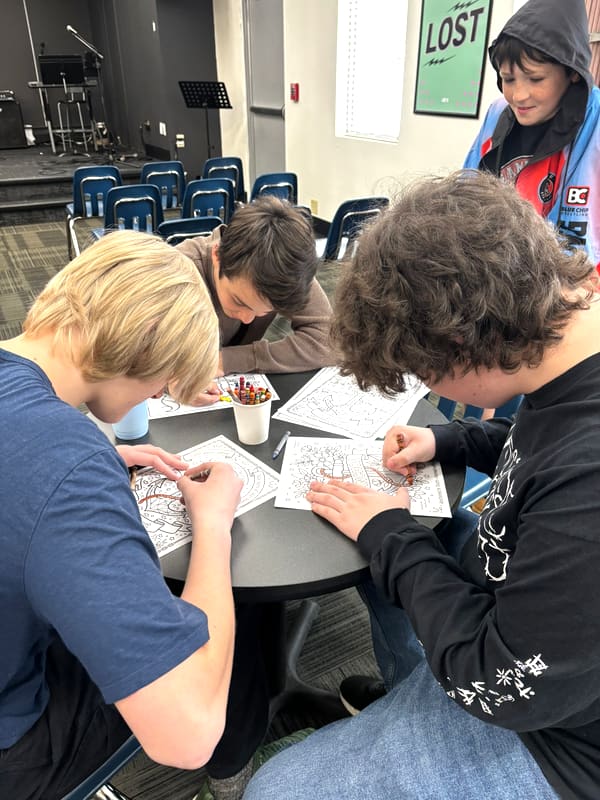 Older Anchor Homeschool Co-op students coloring together during club hour